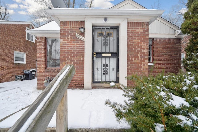 view of snow covered property entrance