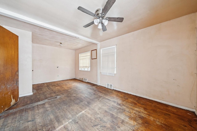 empty room featuring ceiling fan and dark hardwood / wood-style floors