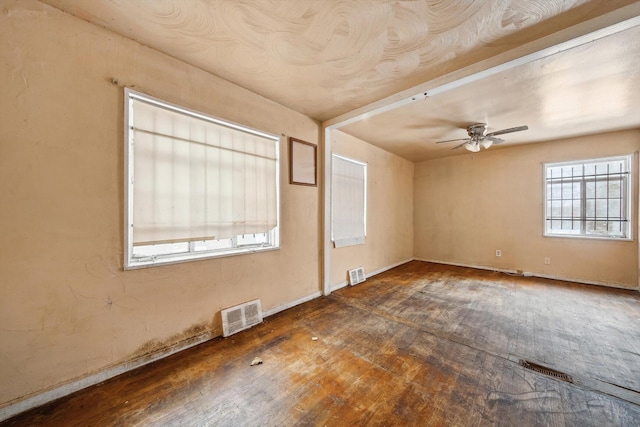 empty room with ceiling fan and dark hardwood / wood-style floors