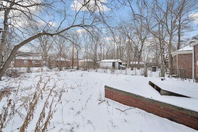 view of yard layered in snow