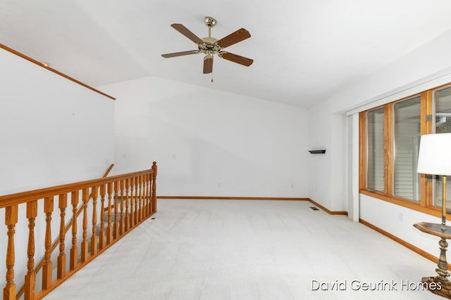 additional living space with ceiling fan, lofted ceiling, and light colored carpet