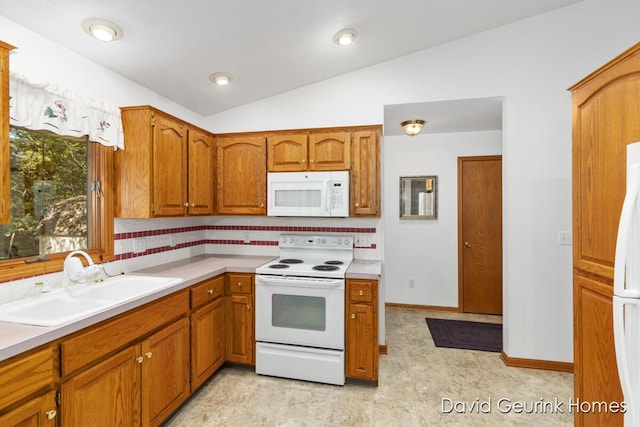 kitchen with vaulted ceiling, sink, white appliances, and decorative backsplash