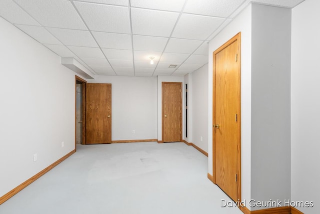 carpeted spare room with a paneled ceiling