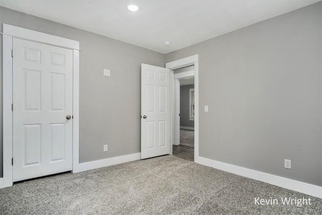 unfurnished bedroom with light colored carpet