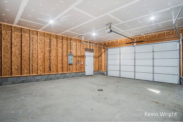 garage with electric panel and a garage door opener