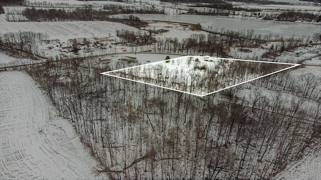 snowy aerial view featuring a rural view