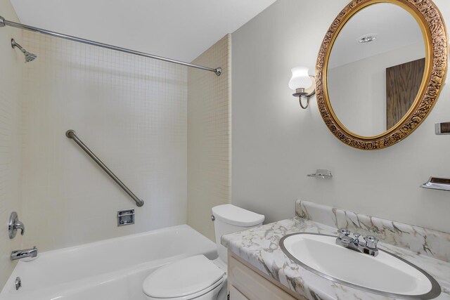 bathroom featuring toilet, vanity, and shower / bath combination