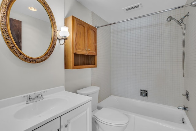 bathroom featuring visible vents, toilet, vanity, and washtub / shower combination