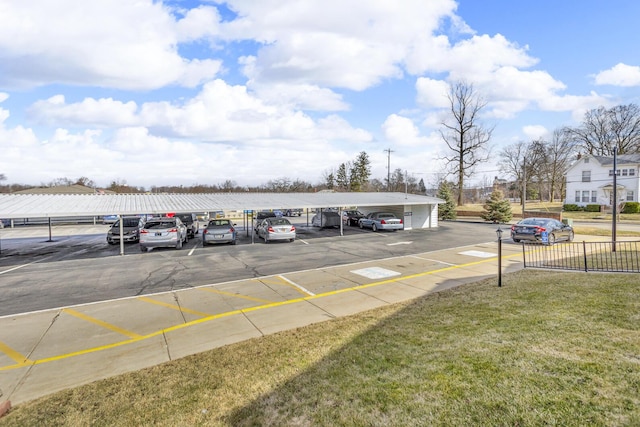 partially covered parking lot with fence