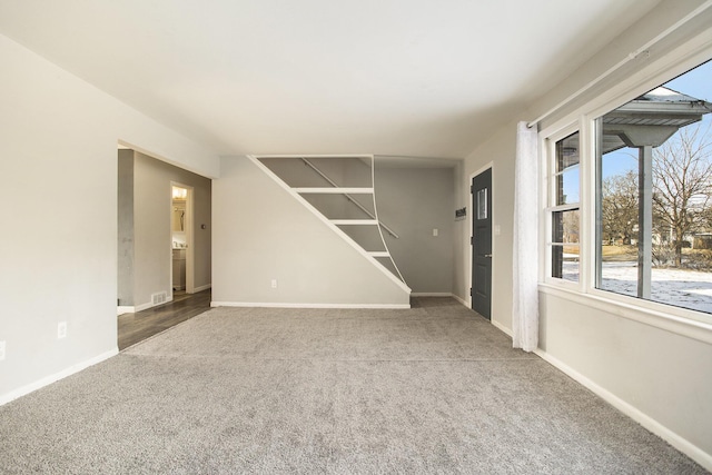 unfurnished room featuring dark colored carpet