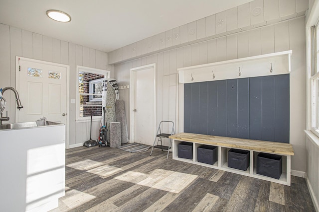 mudroom with wooden walls, dark hardwood / wood-style floors, and sink