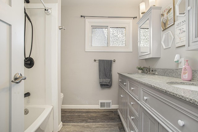 bathroom with vanity, hardwood / wood-style flooring, and  shower combination