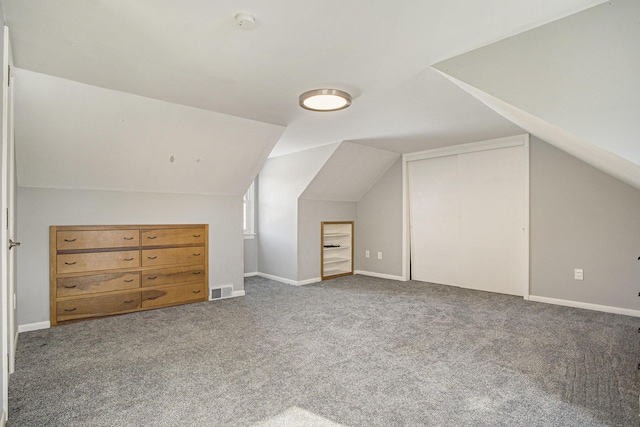 bonus room featuring vaulted ceiling and carpet