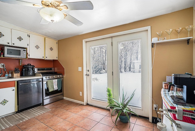 kitchen with white cabinetry, appliances with stainless steel finishes, sink, and light tile patterned floors