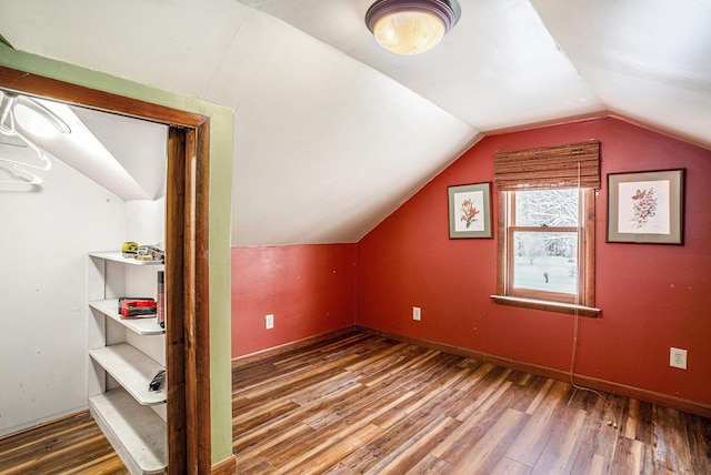 bonus room with hardwood / wood-style floors and vaulted ceiling