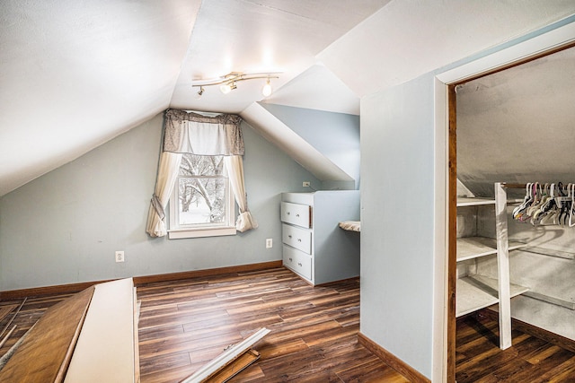 bonus room with lofted ceiling and hardwood / wood-style floors