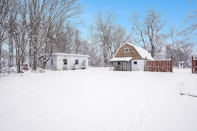 snowy yard featuring an outdoor structure