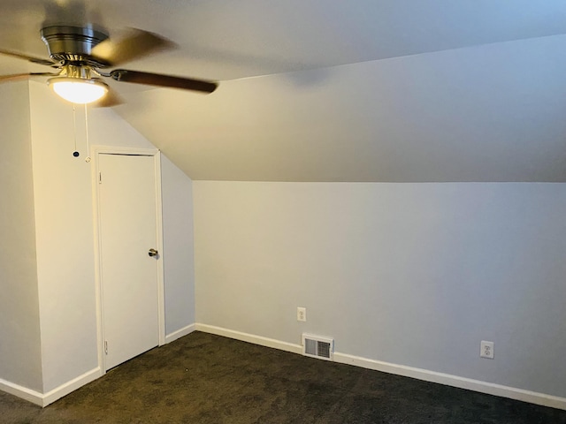 bonus room with ceiling fan, lofted ceiling, and dark colored carpet