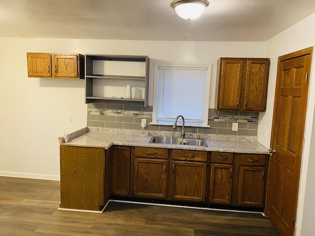 kitchen with tasteful backsplash, sink, and dark wood-type flooring