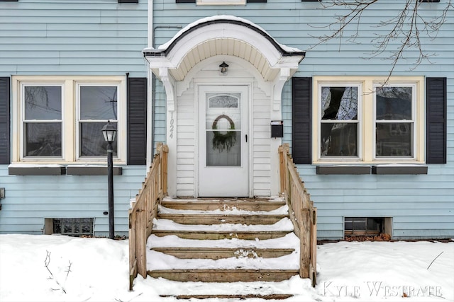 view of snow covered property entrance