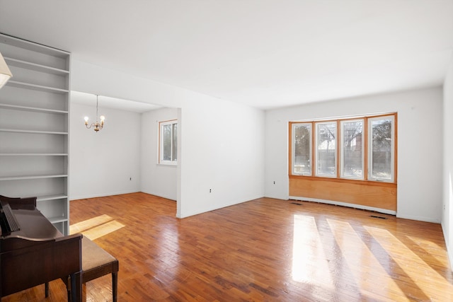 living room with hardwood / wood-style floors and a notable chandelier