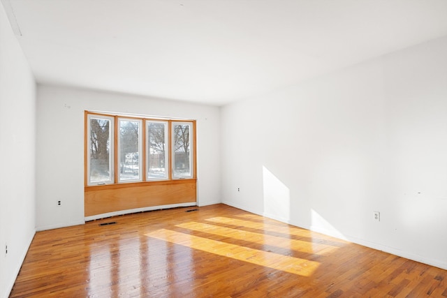 spare room with light hardwood / wood-style flooring