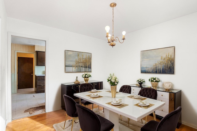 dining room featuring a notable chandelier and light wood-type flooring