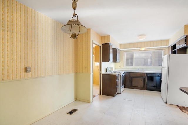 kitchen featuring white appliances and dark brown cabinetry