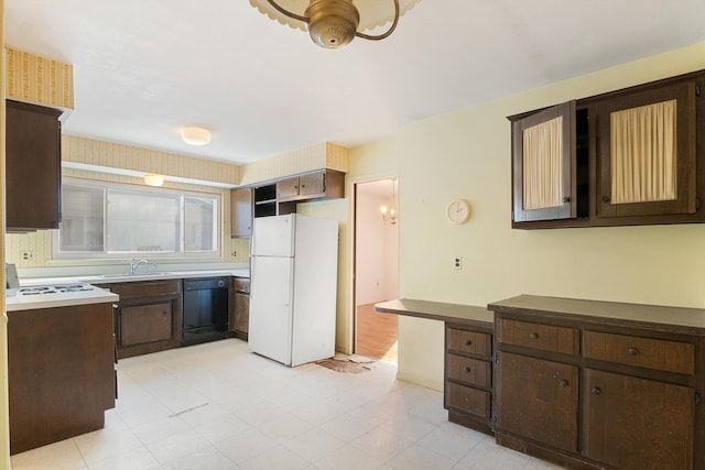 kitchen featuring dishwasher, white fridge, and dark brown cabinets