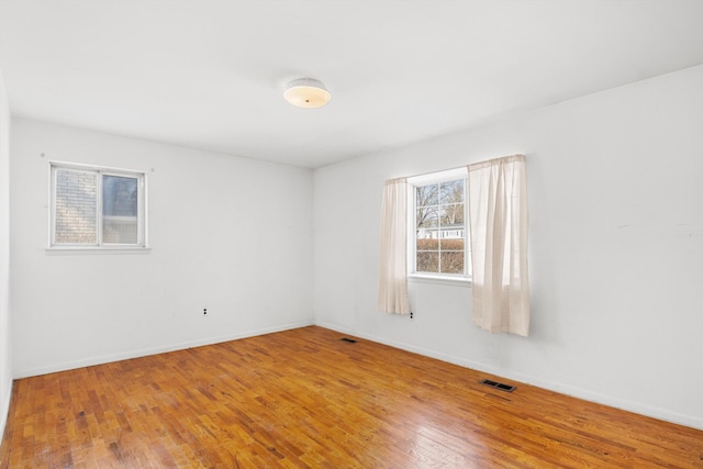 unfurnished room with light wood-type flooring