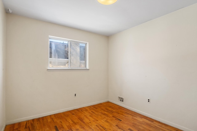 empty room with hardwood / wood-style floors