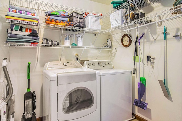 clothes washing area with washer and clothes dryer