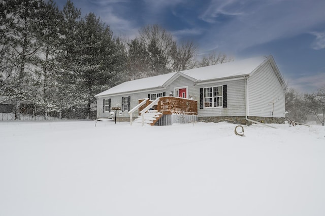 snow covered property with a wooden deck