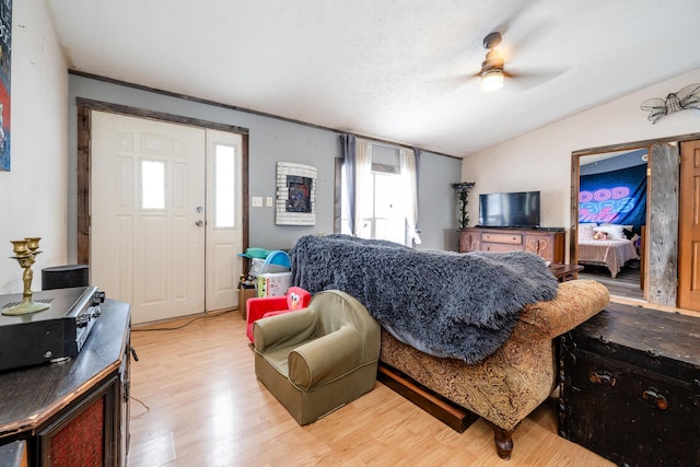 living room with light wood-type flooring, ceiling fan, and lofted ceiling