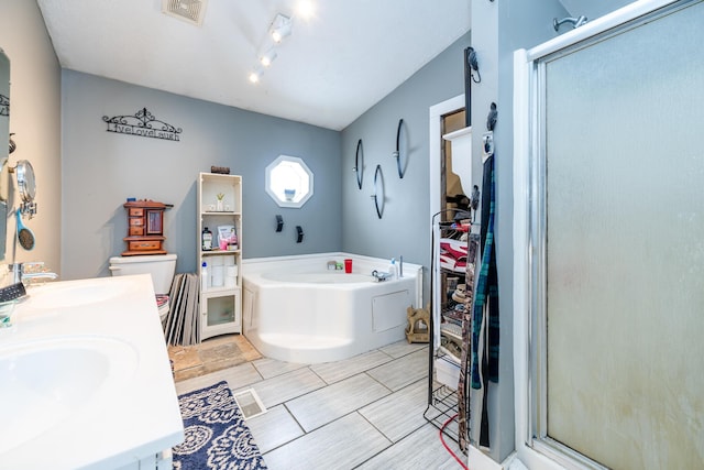 full bathroom featuring toilet, vanity, and separate shower and tub