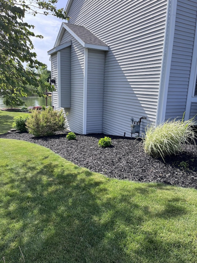 view of side of property with a lawn