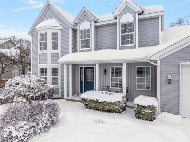 view of front of house featuring covered porch and a garage