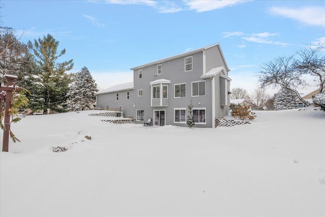 view of snow covered rear of property