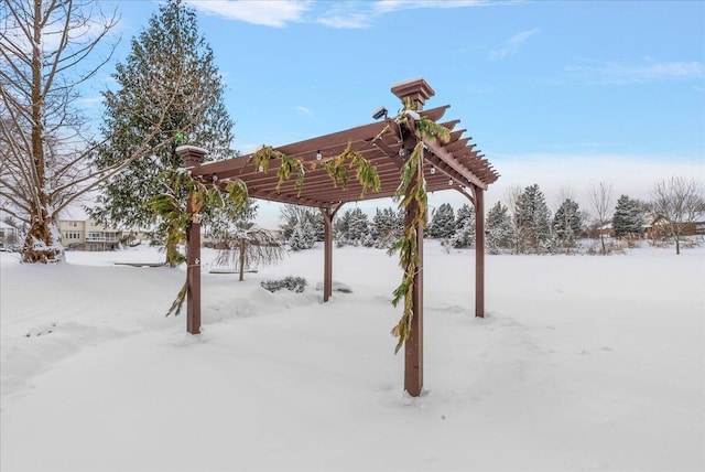 yard covered in snow with a pergola