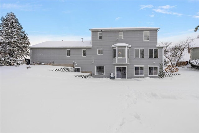 view of snow covered back of property