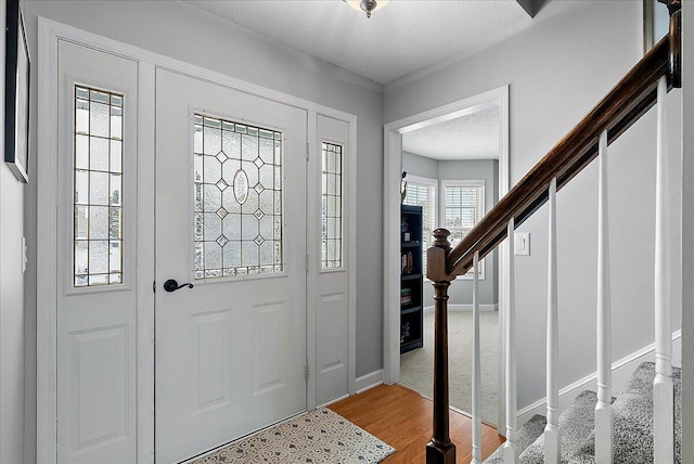 entrance foyer featuring a textured ceiling and hardwood / wood-style floors