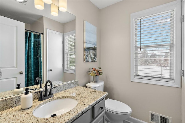 bathroom featuring toilet and vanity