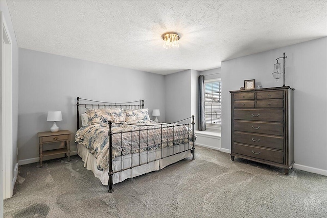 bedroom with carpet floors and a textured ceiling