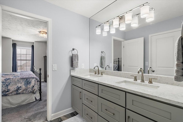 bathroom featuring a textured ceiling and vanity