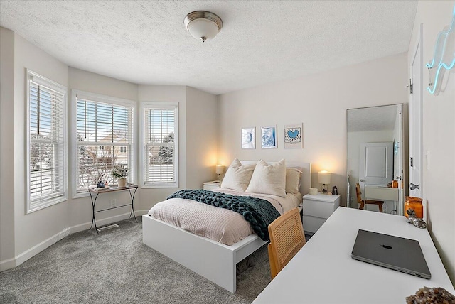 bedroom with carpet and a textured ceiling