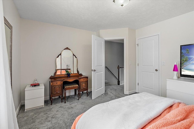 carpeted bedroom featuring a textured ceiling