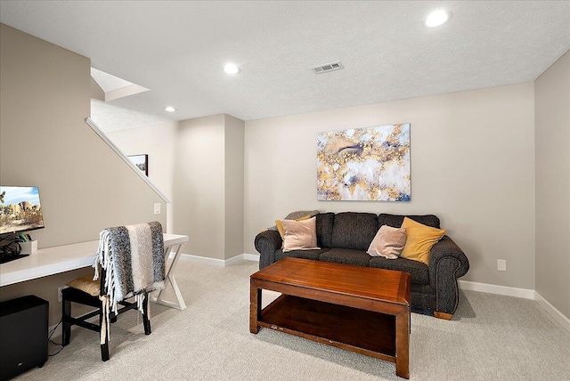 office area featuring light carpet and a textured ceiling