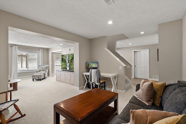 carpeted living room with a textured ceiling