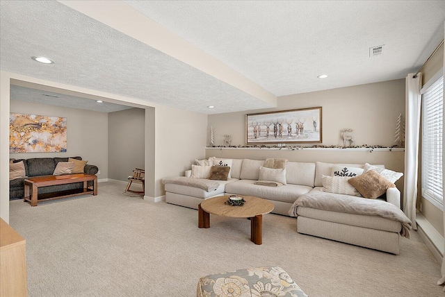 living room featuring light colored carpet and a textured ceiling