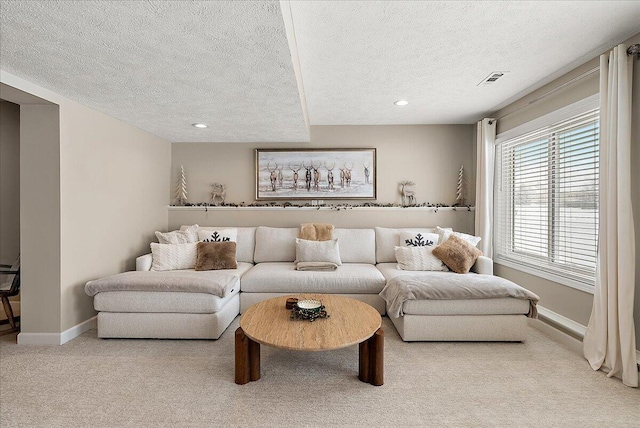 carpeted living room featuring a textured ceiling